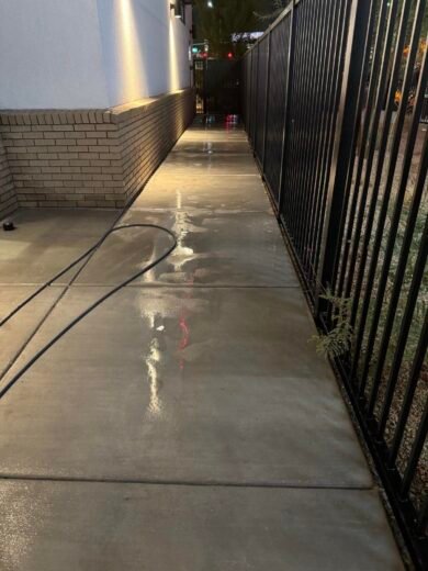 Commercial Sidewalk Cleaning Las Vegas Clean commercial walkway alongside a building at night