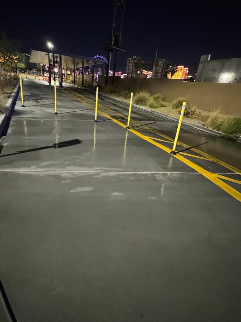 Freshly cleaned drive-thru lane at night with the Las Vegas skyline behind it
