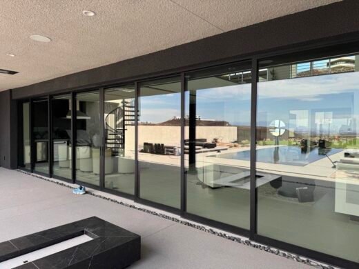 Exterior Window Cleaning Las Vegas Large clean glass sliding doors on a modern Las Vegas home overlooking a pool