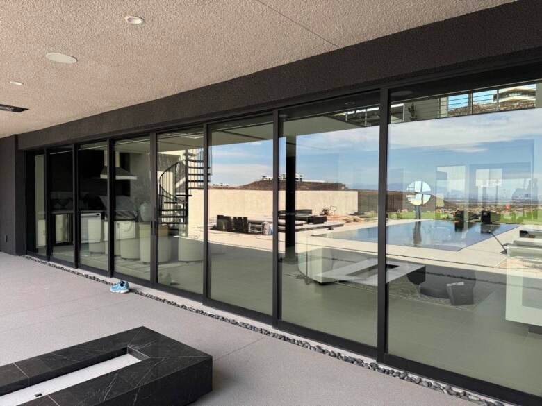 Large clean glass sliding doors on a modern Las Vegas home overlooking a pool