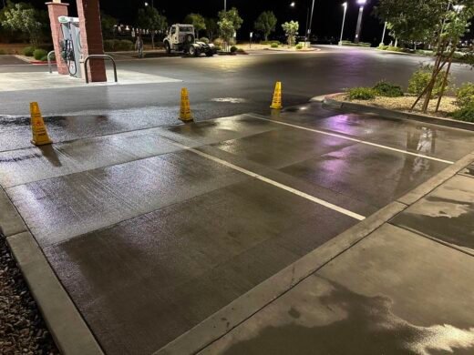Parking Lot Pressure Washing Las Vegas Cleaned commercial parking area at night with wet floor cones and painted stall lines