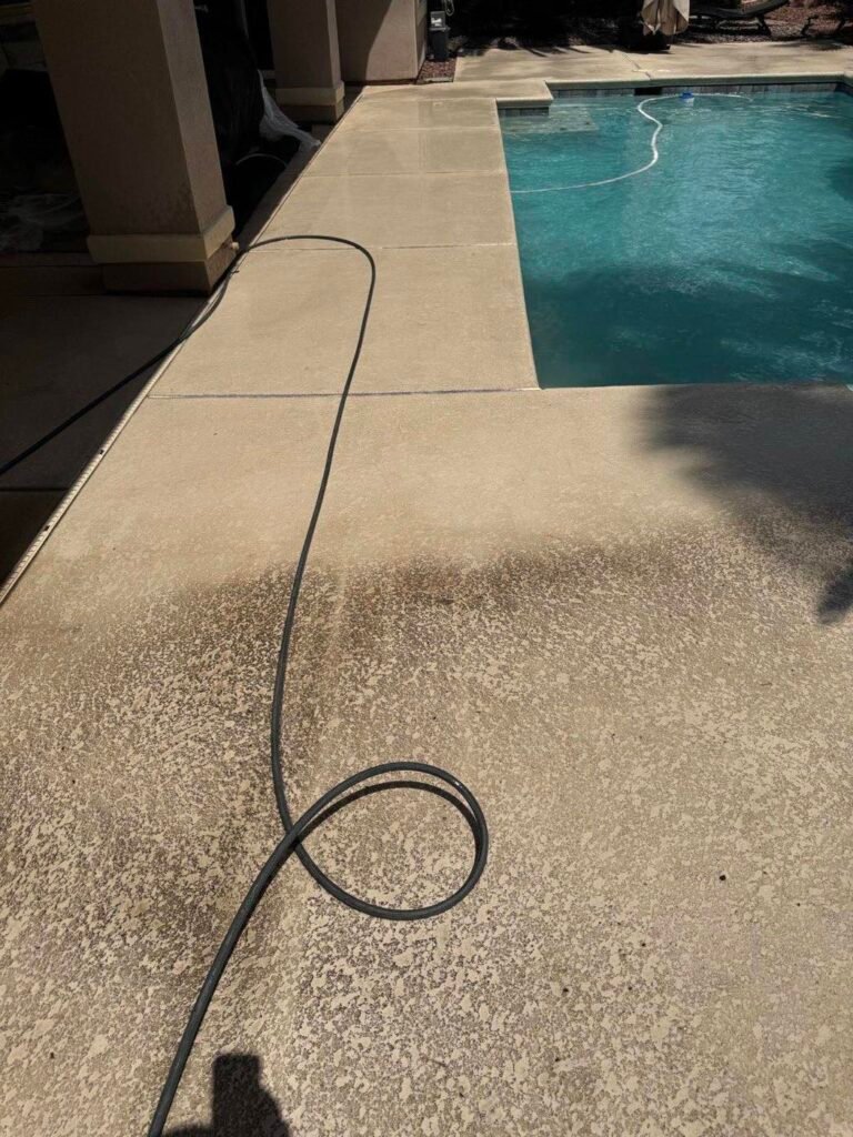 Textured pool deck beside a backyard swimming pool in Las Vegas