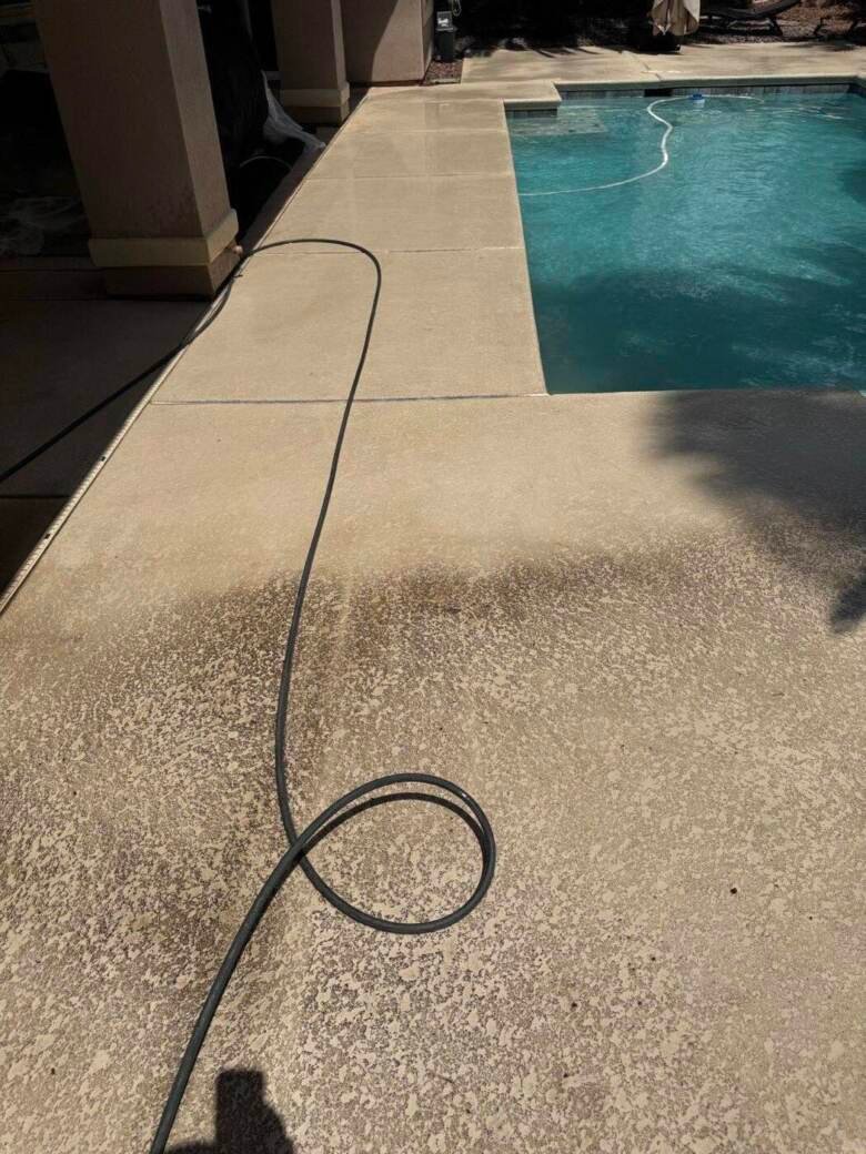 Textured pool deck beside a backyard swimming pool in Las Vegas