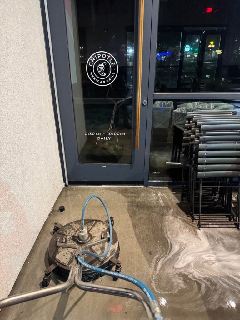 Restaurant entrance being cleaned at night with a surface cleaner and detergent